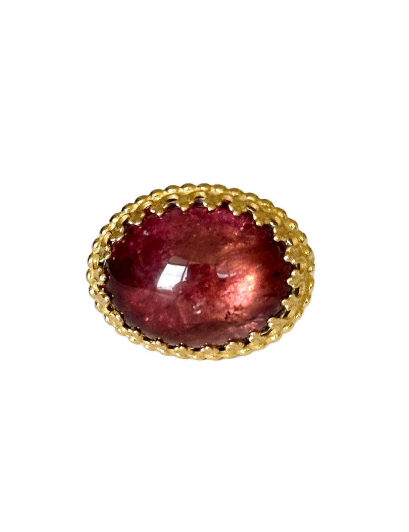 This beautiful 18K recycled gold ring is simple, elegant, and timeless. The 13x18mm oval cabochon Pink Tourmaline is set in a delicate filigree bezel, surrounded by tiny gold dots. The shank has a beautiful pattern. This unique stone will spark joy every time you look at it!