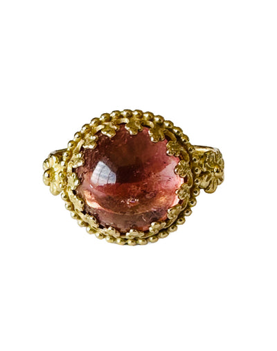 The Fiori ring is made of 18K recycled gold, has an 11mm cabochon Pink Tourmaline stone set in a delicate lacy filigree bezel, surrounded by tiny gold dots. Two beautiful gold flowers adorn the shank right where it meets the stone, and the shank has a snake like pattern on it. This is a gorgeous medium size ring.&nbsp;