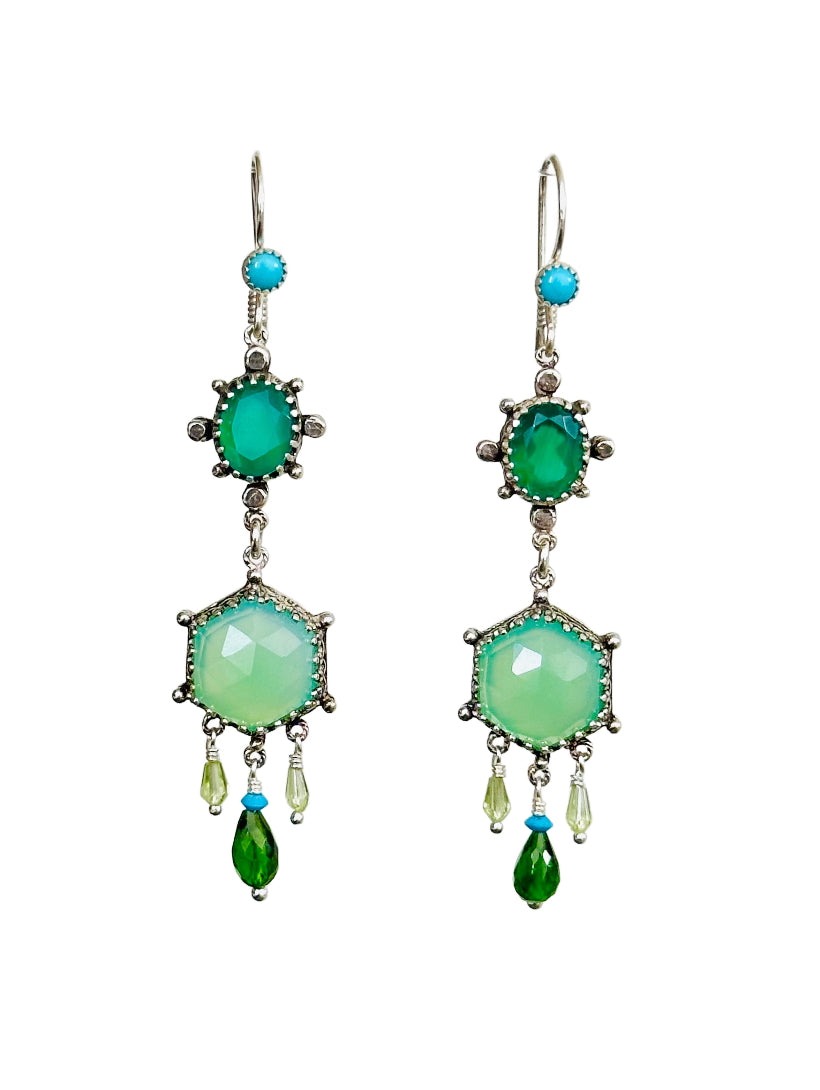 These elegant earrings are a versatile medium &nbsp;size chandelier. They feature a rose cut hexagon chrysoprase framed in a delicate lacy bezel with an open back to let the light shine through.

From the hexagon hangs a faceted tzavorite garnet drop with a small turquoise on top and two small faceted peridot drops on either side.&nbsp;

Above the hexagon is an oval green onyx set in a bezel with silver dot adornments. The ear wires have a turquoise accent.

