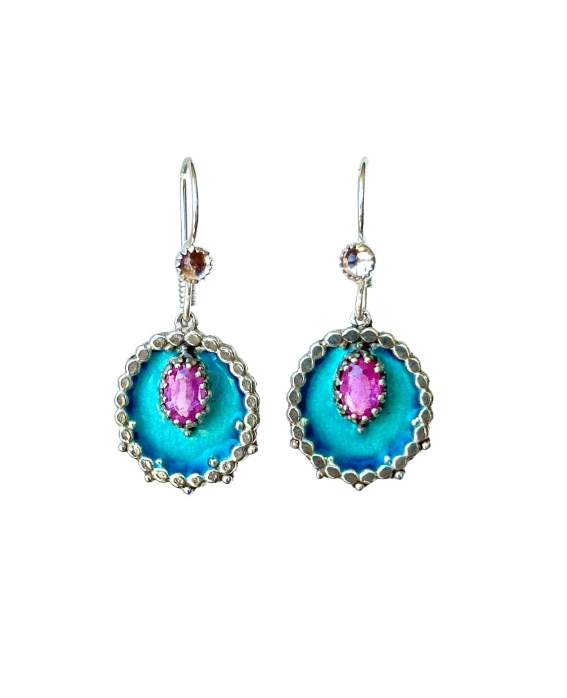 Small Enameled Medallion Pink Sapphire &amp; Pink Tourmaline Earrings

Small oval enameled medallions surrounded by silver dots, with a beautiful faceted pink sapphire set &nbsp;in a lacy bezel. There is a small pink tourmaline accent on the ear wire.&nbsp;

These earrings are small statement pieces that add a pop of color and sophistication to your look.&nbsp;