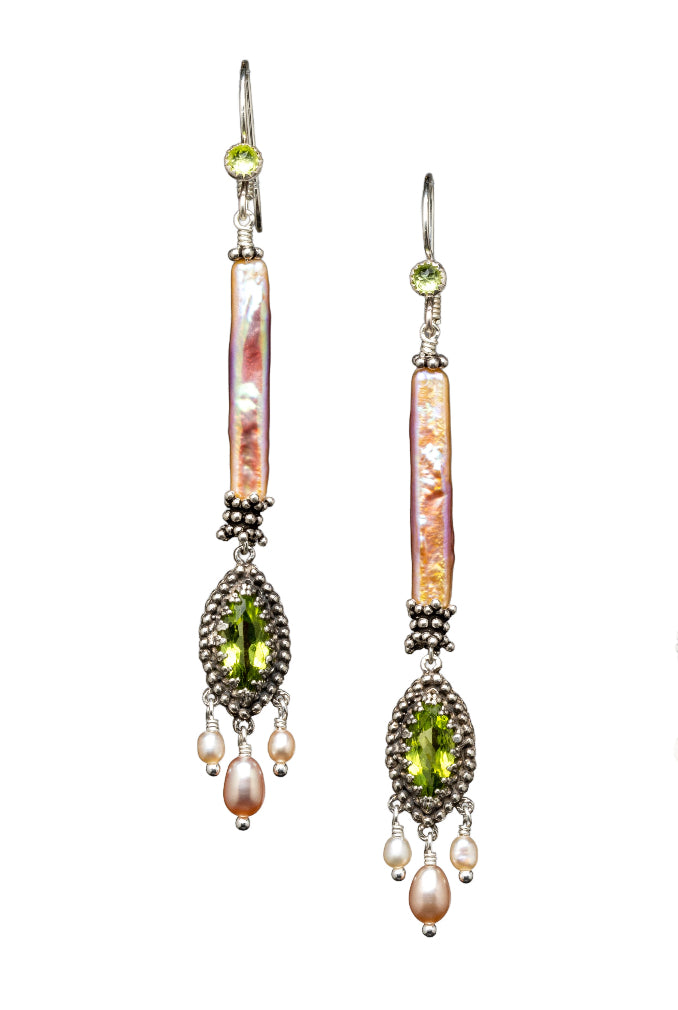 Peridot &amp; Pearl Earrings

Beautiful peridot set in a lacy bezel surrounded by tiny silver dots, and with three pearl dangles. This piece hangs from a long beautiful natural color pearl &nbsp;with great luster. These earrings are elegant, lightweight and versatile.&nbsp;

Materials: Sterling silver, 5x10mm marquis peridot &amp; pearls

Dimensions: 3" including ear wire x 3/8"