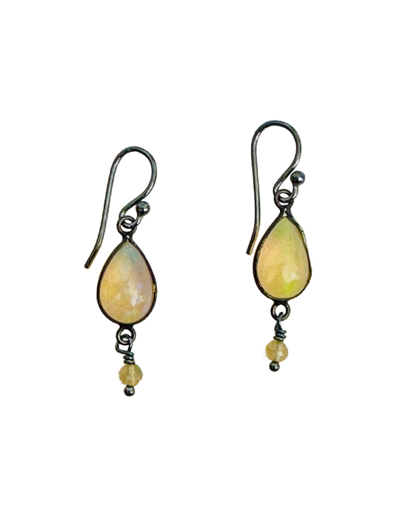 These gorgeous open back Ethiopian Opal drops are wrapped in oxidized silver. The earrings have a small faceted Ethiopian Opal dangle and oxidized silver ear wires.

These earrings are all elegance and simplicity, the opals are gorgeous and have a lot of fire!