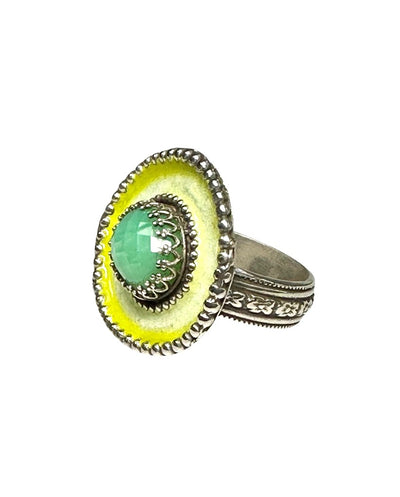 A horizontal 1"x7/8" oval with a light chartreuse with a darker chartreuse border enamel,  has a 11x9mm beautiful rose cut chrysoprase set in the center, in a lacy bezel. The band has a delicate floral pattern, is 1/8" and sturdy.    This ring is a size 8.5  Materials: Sterling silver, enamel & chrysoprase   This ring is unique, fun, beautiful and colorful! 