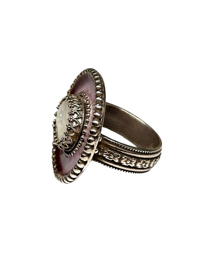 A horizontal 1"x7/8" oval with a pink enamel with a burgundy border,  has a 11x9mm beautiful luster pearl with blister set in the center, in a lacy bezel. The band has a delicate floral pattern, is 1/8" and sturdy.    This ring is a size 6.5  Materials: Sterling silver, enamel & fresh water pearl