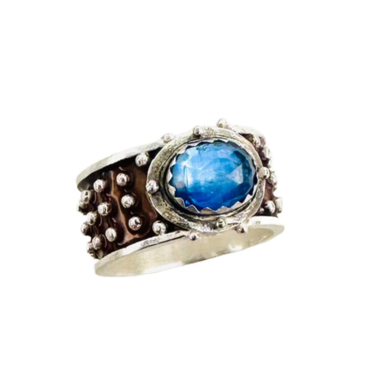 Kyanite Enameled &nbsp;Wide Band Ring&nbsp;

Beautiful enameled band &nbsp;with silver dots all around with a rose cut blue kyanite set horizontally.&nbsp;

Size: 8

Materials: Sterling silver, enamel &amp; kyanite

Dimensions: Kyanite is 9x7mm, ring is 7/16" wide