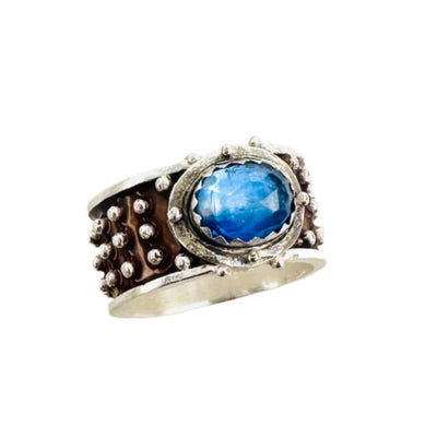 Kyanite Enameled &nbsp;Wide Band Ring&nbsp;

Beautiful enameled band &nbsp;with silver dots all around with a rose cut blue kyanite set horizontally.&nbsp;

Size: 8

Materials: Sterling silver, enamel &amp; kyanite

Dimensions: Kyanite is 9x7mm, ring is 7/16" wide