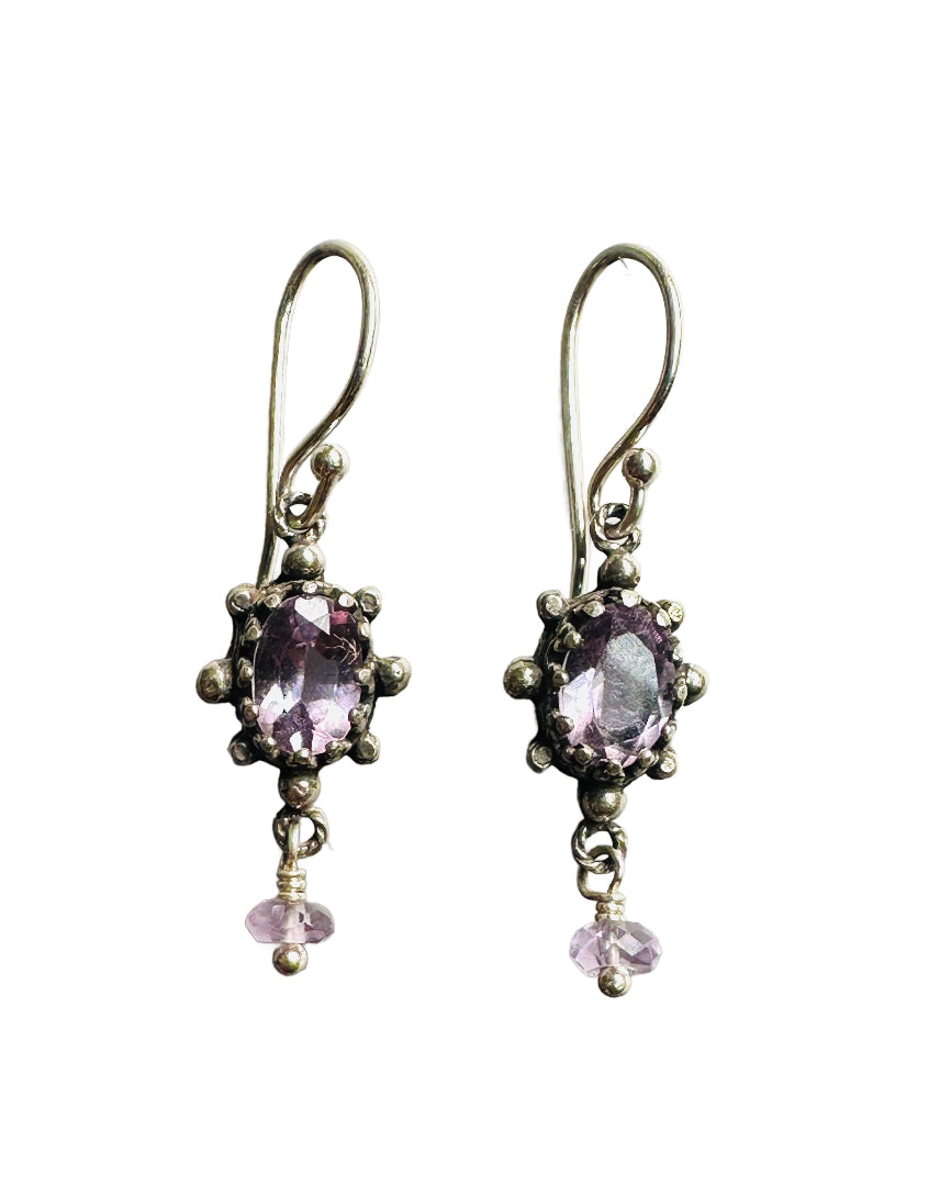 This super cute small earring features a beautiful faceted pink amethyst framed in a delicate, lacy bezel, with little silver dot accents. The stone setting has an open back to allow light to shine through and show the gem's beauty. From the vertical oval setting hangs a cut pink amethyst accent that gives the earring movement