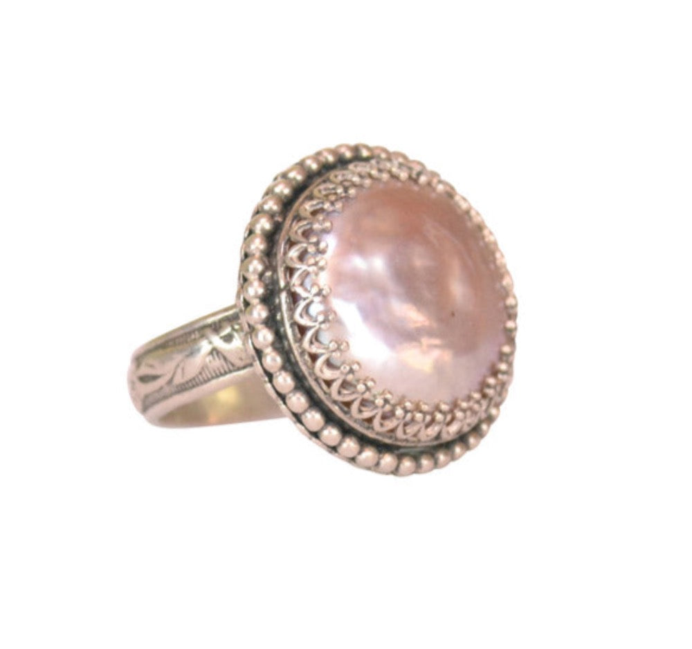 Pearl Cocktail Ring  This is such a fun, and elegant ring! A beautifully 16mm pearl with beautiful luster is set in a filigree bezel, and surrounded by a strand of tiny silver dots. The shank has a beautiful botanical pattern. Perfect with jeans or a gown.