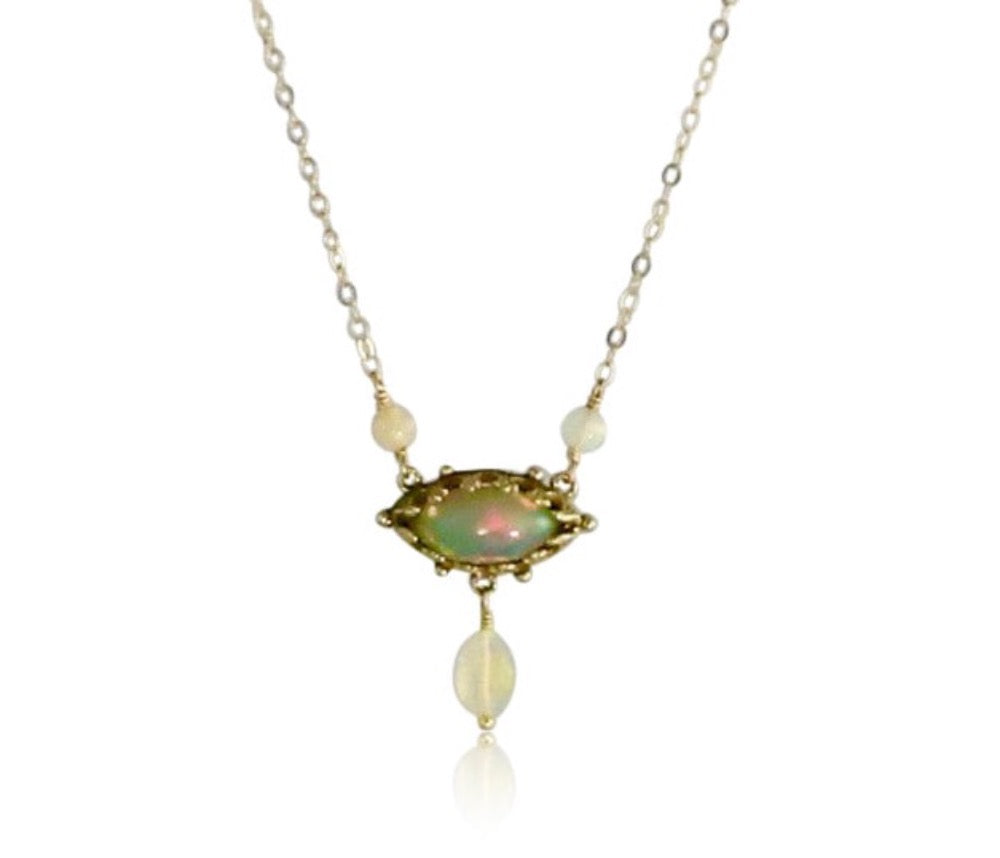 his stunning opal necklace can be worn alone or layered with other favorites. The 12x6mm marquis shaped Ethiopian Opal has a unique pattern 18K recycled goldbezel which gives the simple design a unique look. A faceted Ethiopian Opal hangs from the center of the pendant, and two opals connect the pendant to the 18K gold chain.