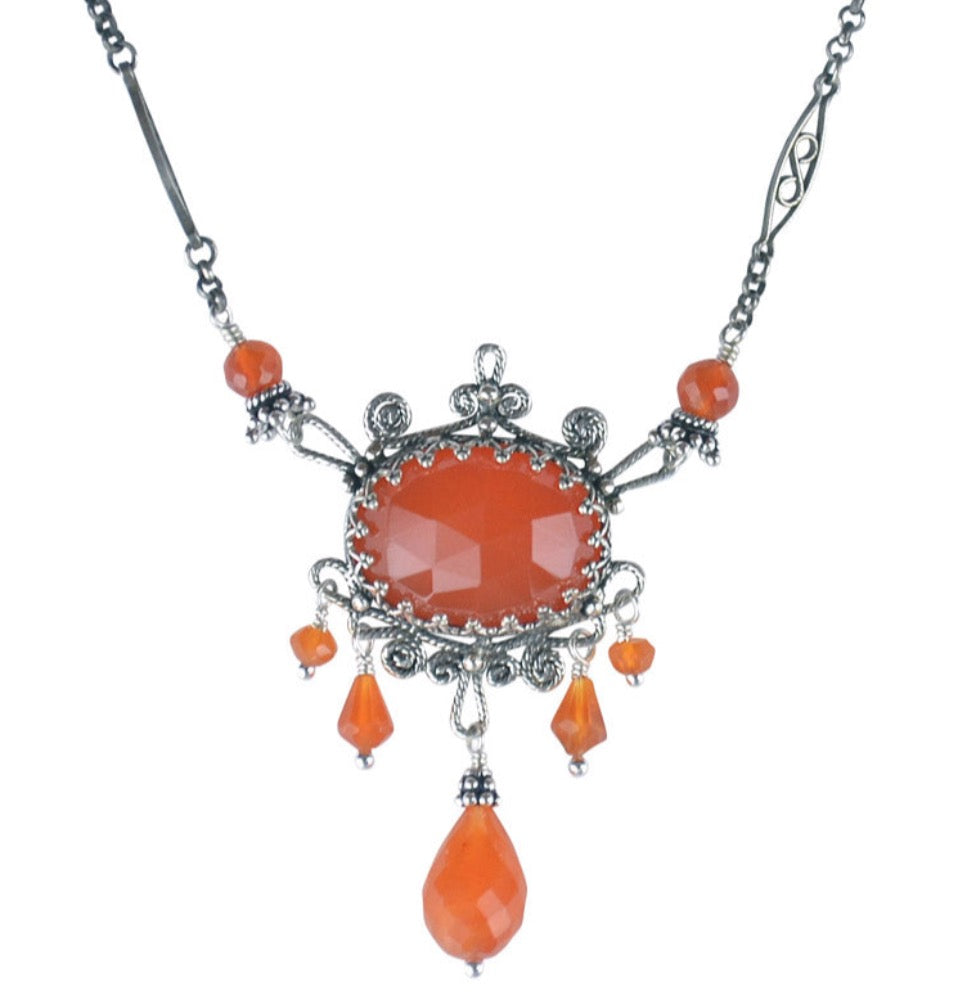 Carnelian Filigree Necklace  Beautiful rose cut 18x13mm carnelian set in a lacy bezel. Filigree work surrounds the stone with carnelian drops. The chain has a beautiful details and carnelian accents. This necklace is 17" long. If you need a different length, please contact us.  Materials: Sterling silver & carnelian