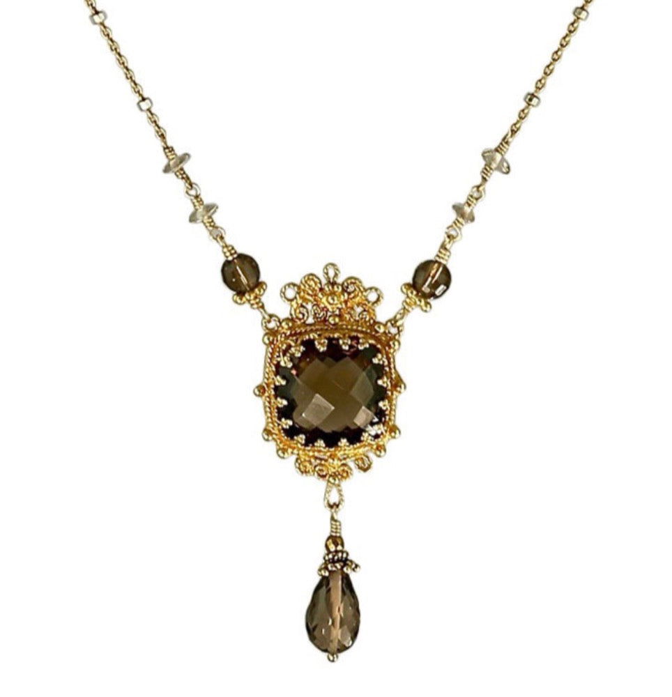 Smoky Quartz Baroque Window Vermeil Necklace Beautiful 12x12mm faceted smoky quartz stone, set in a lacy bezel, surrounded by filigree details. Three graduated smoky quartz beads lead to delicate, chain. Faceted smoky quartz drop hangs from bottom of pendant. This is a classic necklace that can be worn daily.  Materials: 18K goldvermeil, gold-fill & smoky quartz. ​Length: 17 inches